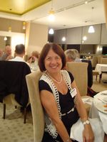 Bozenna sitting at round table smiling at camera